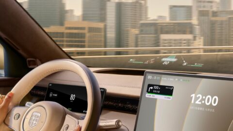 Close-up of the Epicland X9's steering wheel, digital instrument cluster and central touchscreen, with a city skyline outside.