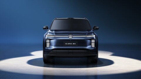 Front view of the blue Volkswagen ID. ERA 8X, showing its full-width light bar and vertically stacked headlights.