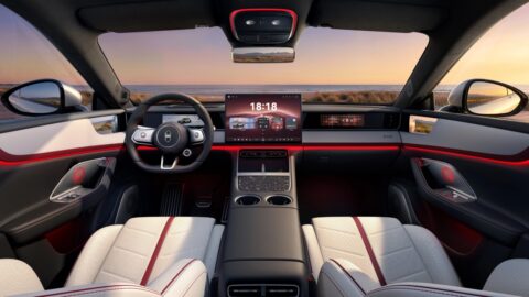 Luxeed RX cockpit featuring a central touchscreen, front-passenger display and red interior accents.