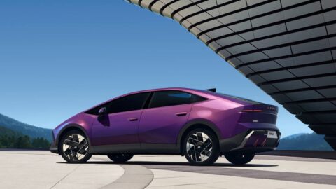 Purple Hyundai Ioniq V viewed from the rear three-quarter angle, showing its fastback design and slim taillights.