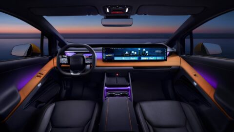Hyundai Ioniq V cockpit with a 27-inch display, orange dashboard trim and purple ambient lighting.
