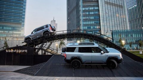 Denza B8 SUVs at an outdoor ramp demonstration in Tashkent, Uzbekistan.