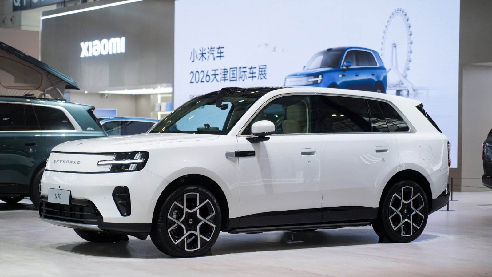 White Xiaomi Sky Nomad N70 SUV displayed at the Tianjin auto show, viewed from the front three-quarter angle.