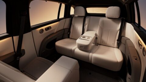 The rear seats of the 2026 Li i6 in cream leather, with a fold-down center armrest with cupholders, a rear sunshade and warm ambient lighting. The front passenger seat is folded fully forward to extend legroom.