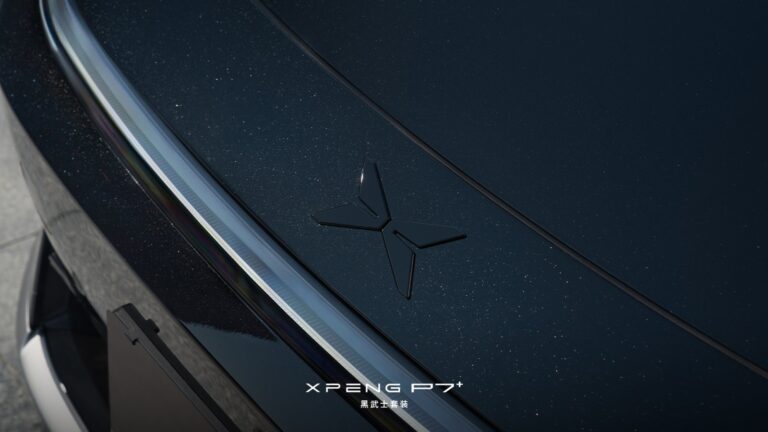 Close-up of the blacked-out Xpeng logo on the hood of the P7+ Black Knight edition, set against metallic dark blue-black paint with chrome window trim.