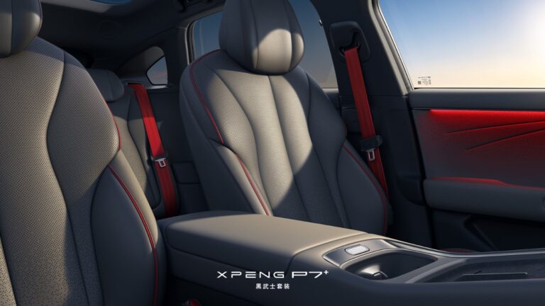 Interior of the Xpeng P7+ Black Knight package, showing dark grey perforated leather front seats with red stitching and piping, red seat belts and red ambient lighting on the door panel.