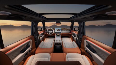 Wide view of the Geely Galaxy Cruiser 700 cabin showing two-tone seats, a panoramic sunroof and the dashboard.