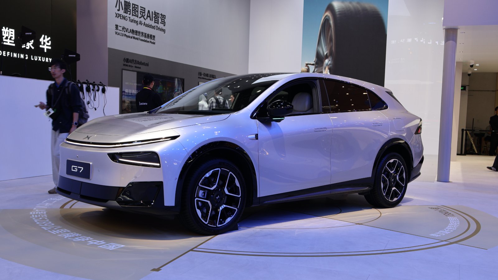 Front three-quarter view of a silver Xpeng G7 SUV on display at the Beijing auto show.