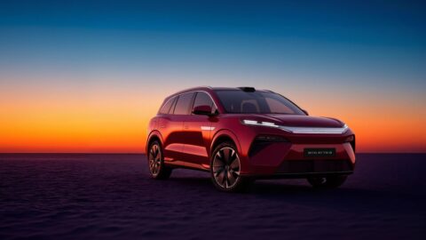 Red BYD Atto 8 viewed from the front at sunset.