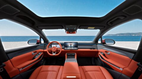 BYD Atto 8 cabin with orange upholstery, a central touchscreen and a panoramic glass roof.