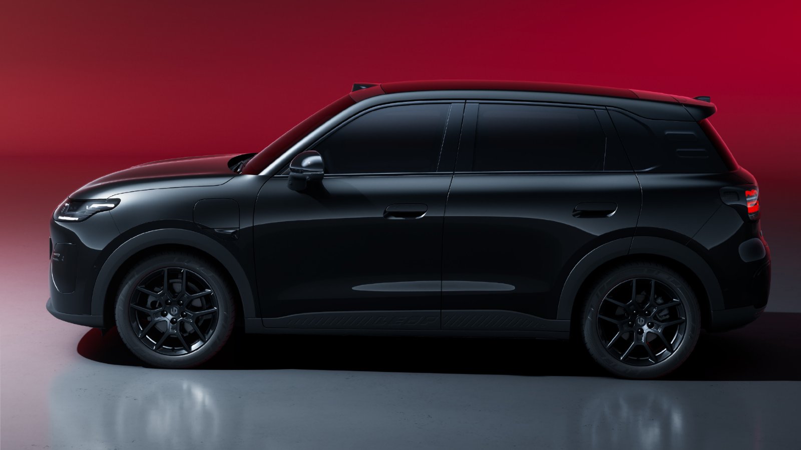Side view of a black Leapmotor A10s electric SUV with black wheels against a red backdrop.