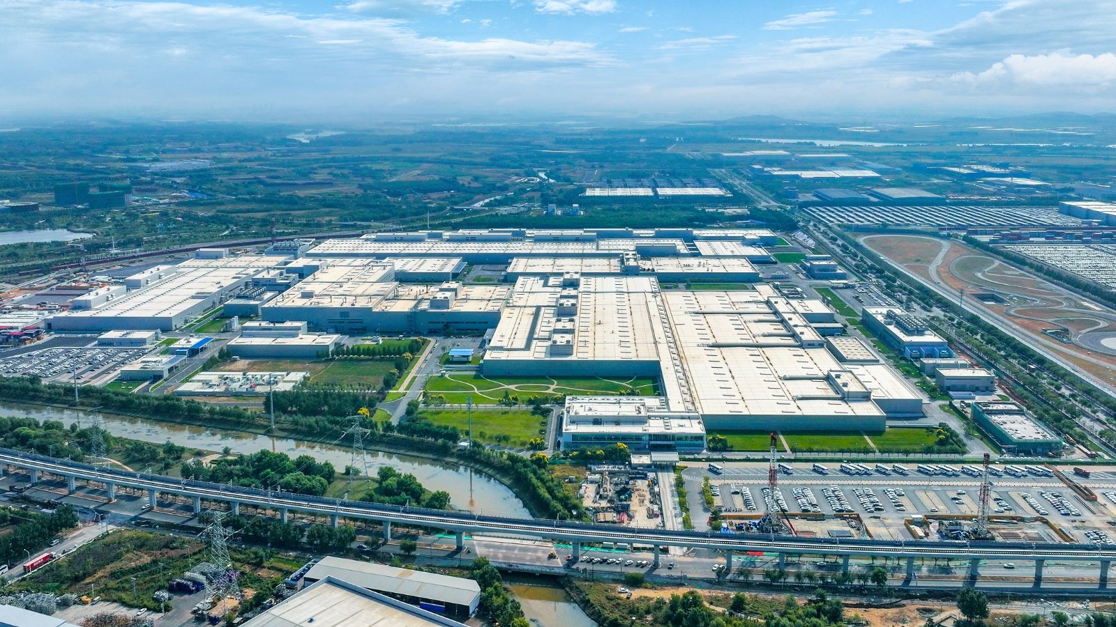 Aerial view of BMW's production complex in Shenyang, showing factory buildings and surrounding roads.
