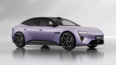 Purple Avatr 06 sedan with a contrasting black roof and dark alloy wheels against a gray studio background.