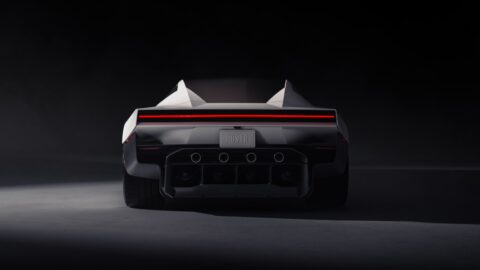 Rear view of the Tesla Roadster with a full-width red taillight and circular outlets above the diffuser.