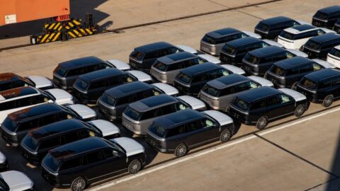 Elevated view of Xpeng GX SUVs parked in rows at a shipping terminal.