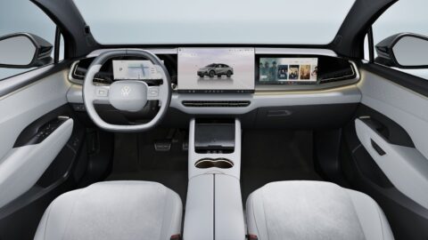 Volkswagen ID. UNYX 07 cabin with light-colored seats, a digital instrument display, a central touchscreen and a passenger screen.