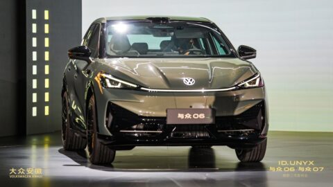 Front view of a Volkswagen ID. UNYX 06 SUV displayed on an illuminated stage.