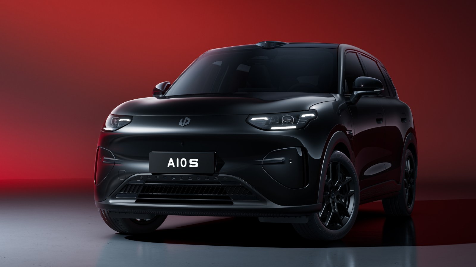  Black Leapmotor A10s in a front three-quarter view, with roof-mounted LiDAR and black alloy wheels against a red backdrop.