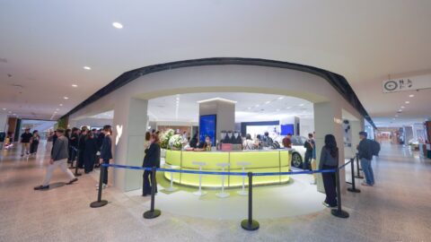Visitors gather around the curved entrance and illuminated counter of the Firefly store at Bangkok's centralwOrld.