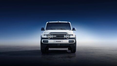 Front view of a white iCar V25 with round headlights and a rectangular grille.